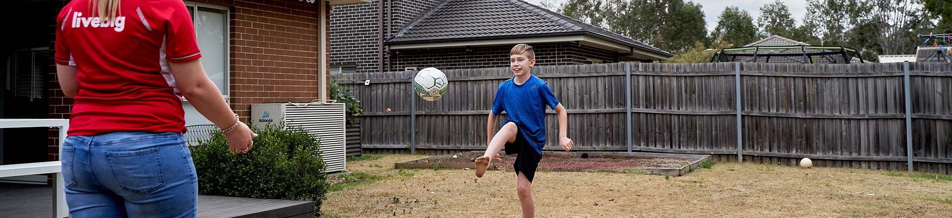 Boy with disability kicking a ball