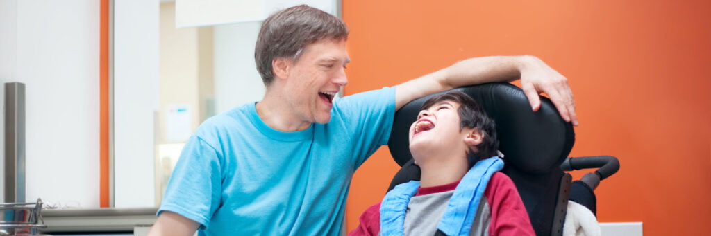 image: boy with disability with parent